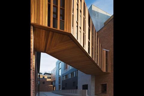 This glass and timber bridge links the new complex to the university’s existing building